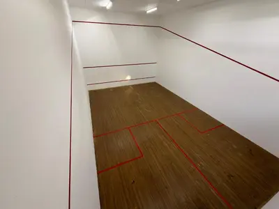 a room with a wooden floor and white walls at Casa Della Monument Park in Pretoria