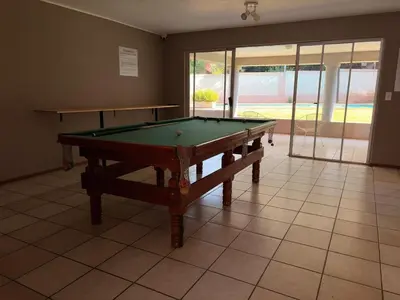 a pool table sitting on a tiled floor at Casa Della Monument Park in Pretoria