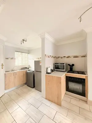 an empty kitchen with a stove and a microwave at Casa Della Monument Park in Pretoria