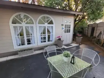 a patio with a table and chairs in front of a house at Casa de Santos Bed and Breakfast Solar and Water off grid in Benoni