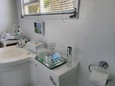 a white bathroom with a sink and a toilet at Casa de Santos Bed and Breakfast Solar and Water off grid in Benoni