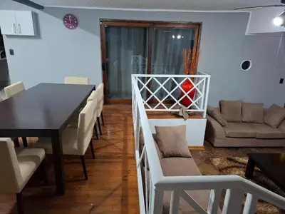 a living room with a table and chairs and a couch at Junior's inn place in Hartbeespoort