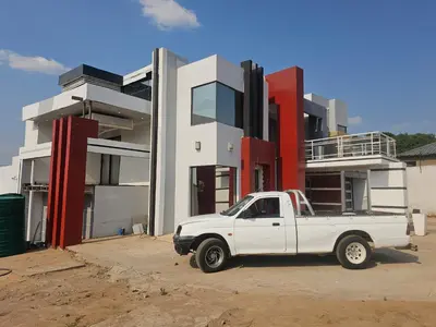 a white truck parked in front of a building at Turfloop guest house