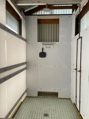 an empty room with white doors and a tile floor at Eindelik on de Lange in Graskop