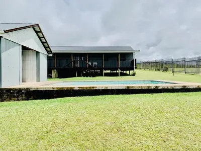 a house with a pool in the middle of a field at Eindelik on de Lange in Graskop