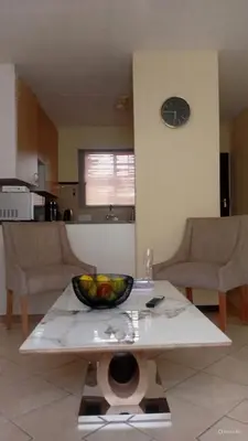 a living room with a bowl of fruit on a table at Pretoria North Royal-IN in Akasia