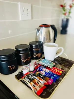 a counter with a tray of food and a cup of coffee at Lagoon Aparthotel in Pretoria