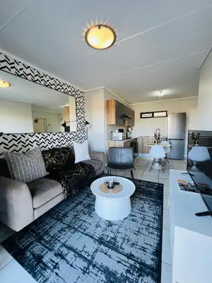 a living room with a couch and a table at Lagoon Aparthotel in Pretoria