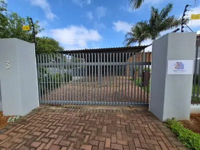 a gate in a driveway with a fence at The Marley in Polokwane