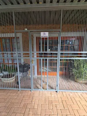 a cage with two dogs inside of it at The Marley in Polokwane