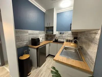 a small kitchen with a sink and a counter at The Marley in Polokwane