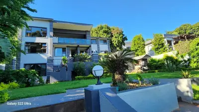 a house with a garden in front of it at 16 Sleeper Holiday Home-Mansion in Hartbeespoort