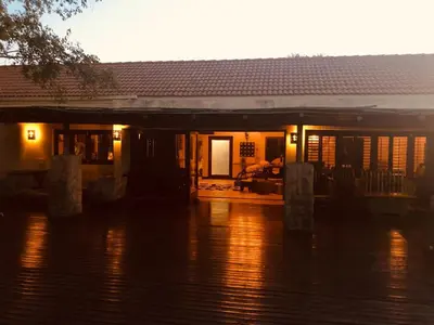 a house on a flooded street with water in front of it at Luxury Villa at Elements Golf Course - Bela Bela in Warmbaths