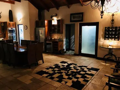 a kitchen and dining room with a checkered floor at Luxury Villa at Elements Golf Course - Bela Bela in Warmbaths