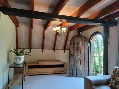 a living room with a couch and a wooden table at The Swiss Garden in Midrand
