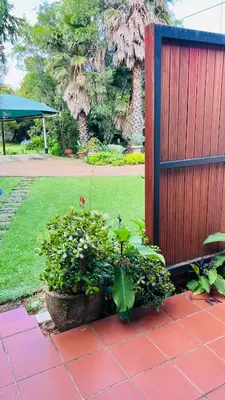 a garden with plants and a wooden fence at Midrand Manor Guesthouse in Midrand