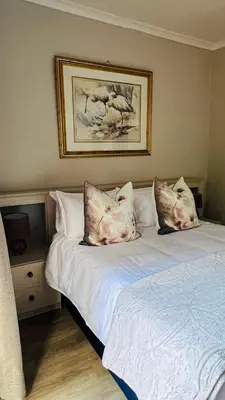 two beds with pillows on them in a bedroom at Midrand Manor Guesthouse in Midrand