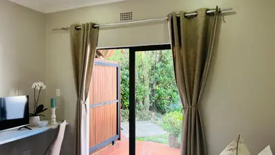 a room with a sliding glass door to a patio at Midrand Manor Guesthouse in Midrand