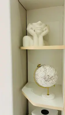 a shelf with a plate and a sculpture on it at Midrand Manor Guesthouse in Midrand