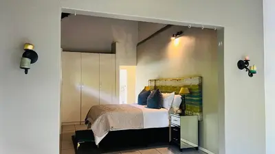 a bedroom with a large bed in a room at Midrand Manor Guesthouse in Midrand