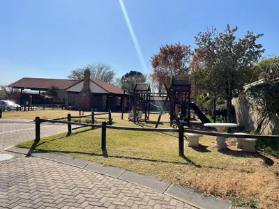 a park with a playground with a slide at The House of Cataleya in Midrand