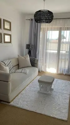 a living room with a white couch and a table at The House of Cataleya in Midrand