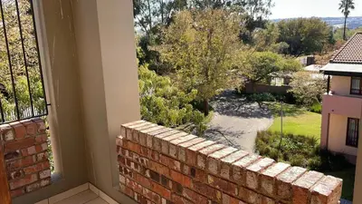 a view from a window of a brick wall at The House of Cataleya in Midrand