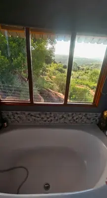 a bath tub in a bathroom with a window at Mathian Farm lifestyle in Tonteldoos