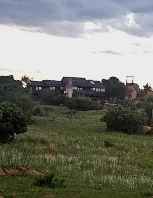 a field of grass with a building in the background at Mathian Farm lifestyle in Tonteldoos