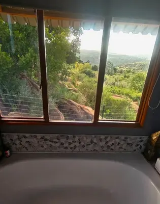 a bath tub in a bathroom with a window at Mathian Farm lifestyle in Tonteldoos