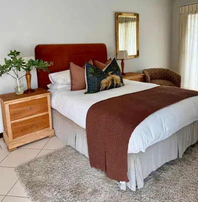 a bedroom with a large bed and a wooden dresser at Private African Retreat at 3000ha Mangweni Game Reserve in Elandsbosch