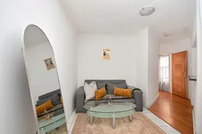 a living room with a couch and a mirror at GlenAustin Garden Haven in Midrand