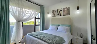 a bedroom with a bed and a window at Penthouse Menlyn in Pretoria