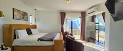 a bedroom with a bed and a balcony at Penthouse Menlyn in Pretoria