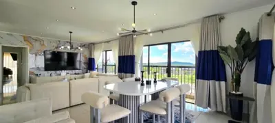 a living room with a white table and chairs at Penthouse Menlyn in Pretoria