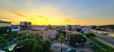 a view of a city at sunset at Penthouse Menlyn in Pretoria