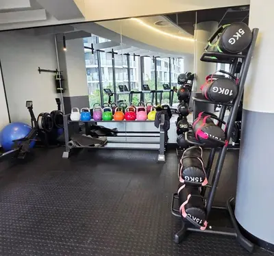 a gym with a bunch of equipment in a room at Serenity Escape at Ellipse Waterfall in Midrand