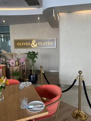 a restaurant with a wooden table and red chairs at Executive Studio at Ellipse Galileo - Waterfall in Midrand