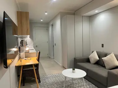 a living room with a couch and a table at Executive Studio at Ellipse Galileo - Waterfall in Midrand