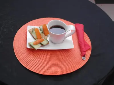 a plate of food and a cup of coffee on a table at Red Square Home in Pretoria