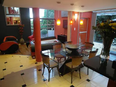 a living room with a table and chairs at Red Square Home in Pretoria