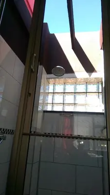 a glass door in a building with a window at Red Square Home in Pretoria