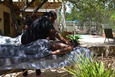 a man is getting his hair cut by a barber at Africana Properties Impala Private Villa in Hoedspruit
