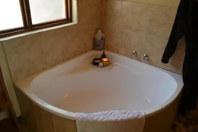 a bath tub with a bowl of fruit in it at Africana Properties Impala Private Villa in Hoedspruit