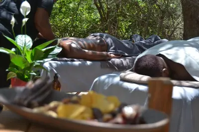 a bronze statue of a man laying on a bed at Africana Properties The Village 25 in Hoedspruit
