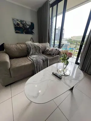 a living room with a couch and a coffee table at Mabiyela at Ellipse Waterfall in Midrand