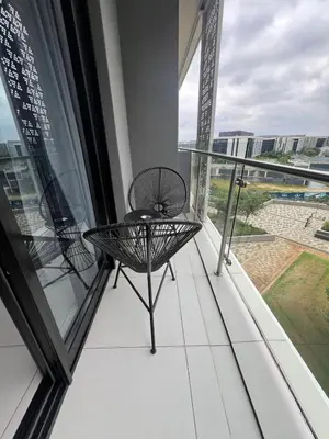 a balcony with a table and a window at Mabiyela at Ellipse Waterfall in Midrand