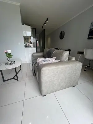 a living room with a couch and a table at Mabiyela at Ellipse Waterfall in Midrand