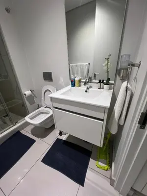 a white bathroom with a sink and a toilet at Mabiyela at Ellipse Waterfall in Midrand