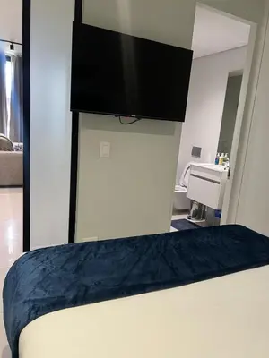 a bedroom with a bed with a television on the wall at Mabiyela at Ellipse Waterfall in Midrand